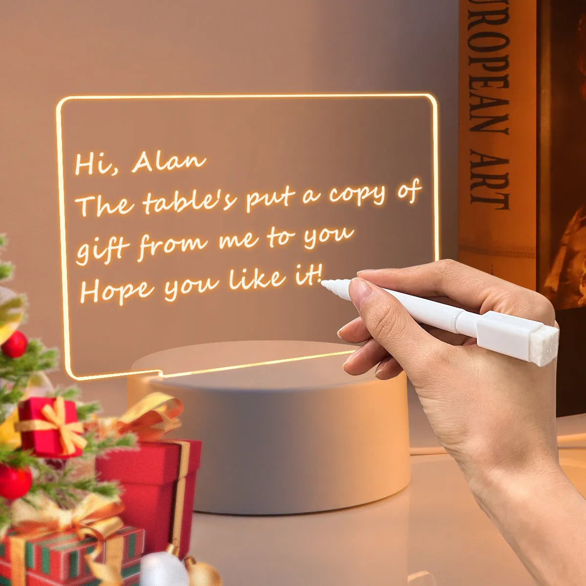 Heart-shaped LED light note board with USB warm yellow glow, base, and pen on a desk