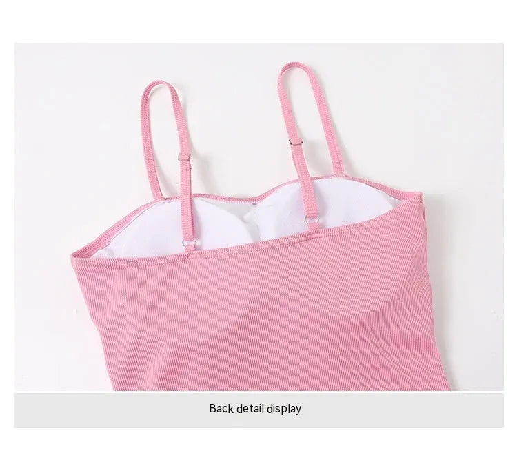 Women's long sleeve one-piece swimsuit in black or pink, made from polyester fabric.