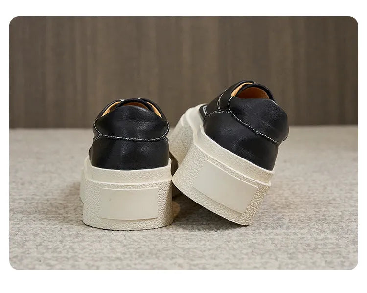 Women's black embossed cowhide platform sports board shoes with a rubber sole.