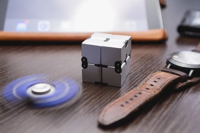 Zinc alloy infinity cube fidget toy showing rotating cube mechanism in metallic finish