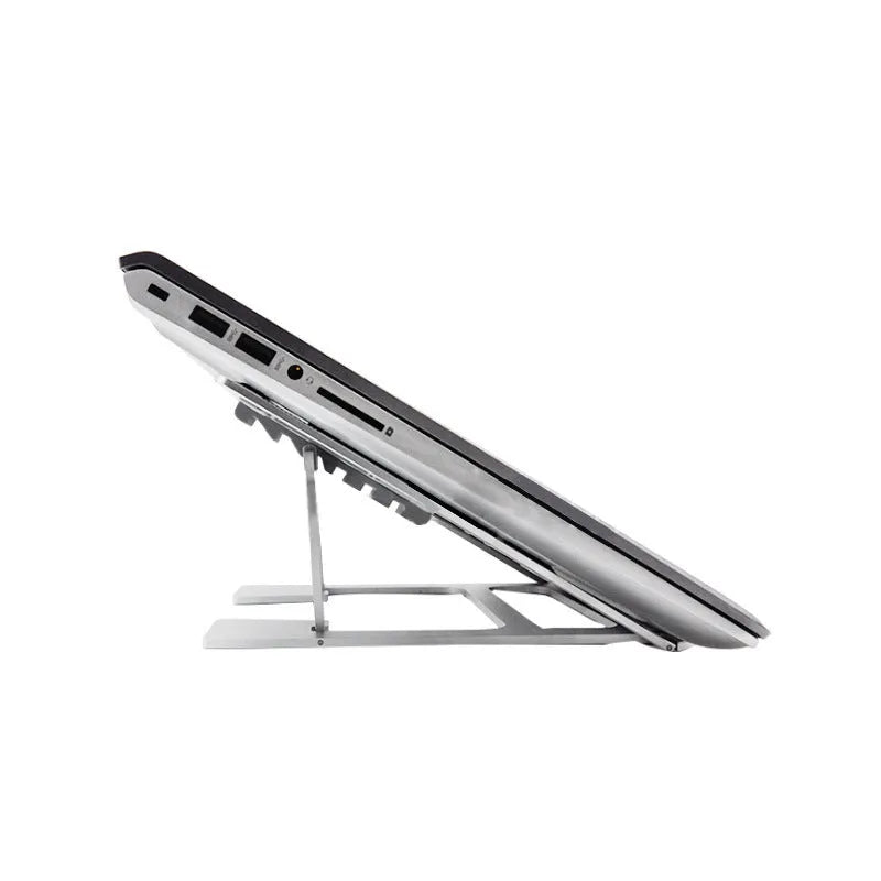 Foldable silver aluminium laptop stand with silicone grips on a desk, showing adjustable angle