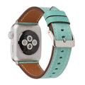 Genuine leather watch strap with a folding buckle in various colours on a grey background.