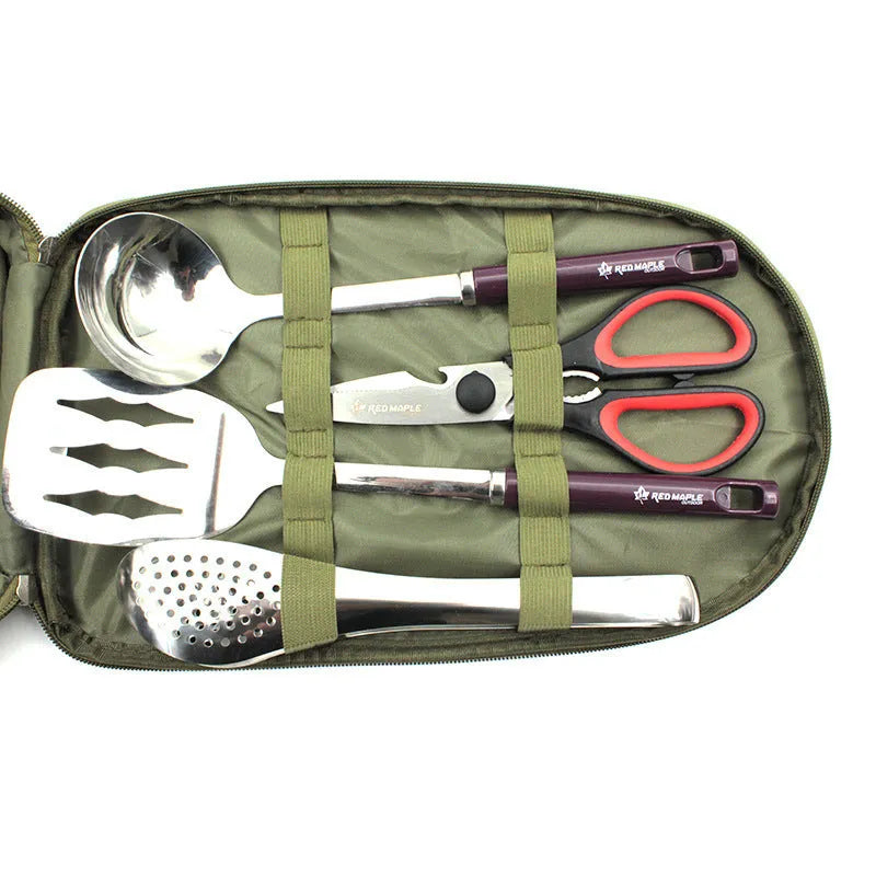 8-piece stainless steel camp kitchen cooking utensil set in black Oxford storage bag on green background