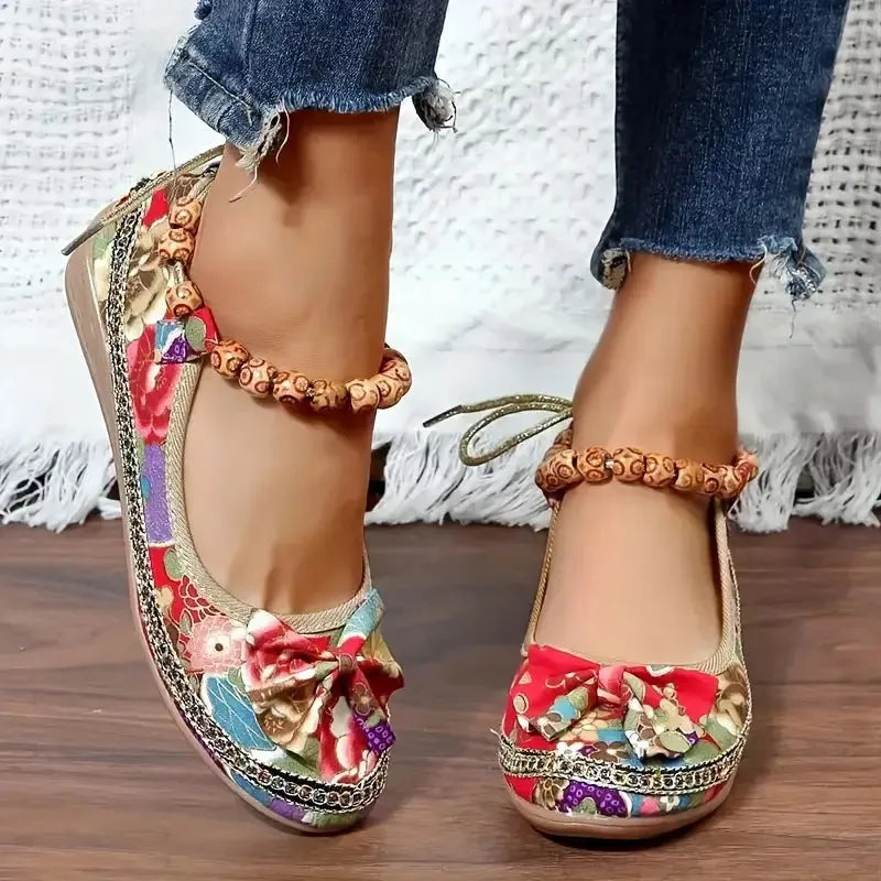 Women's plus size black ethnic platform sandals with cloth upper and elastic band, shown from the side.