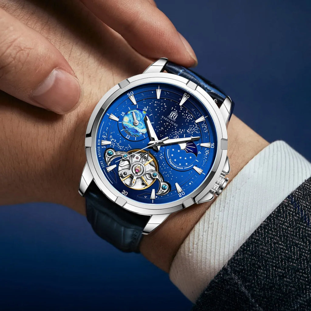 Men's blue dial automatic mechanical watch with a stainless steel bracelet on wrist.