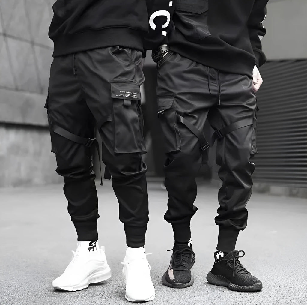 Men's black cotton cargo joggers with drawstring waist and side velcro pockets, loose harem fit