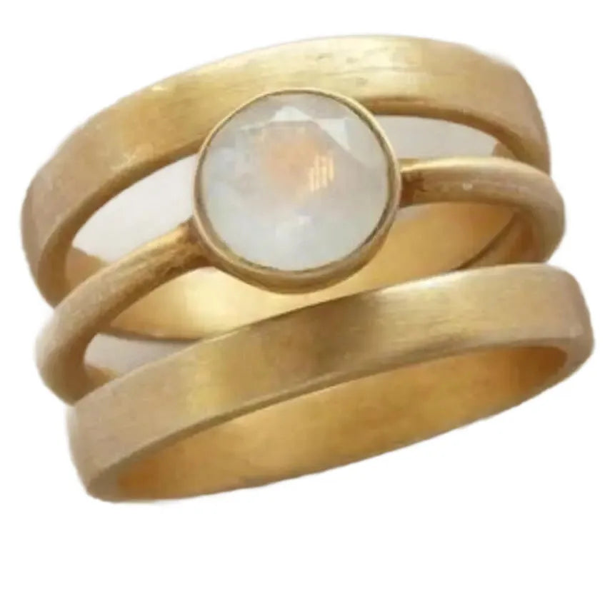 Gold-plated geometric ring with hollow design and a micro-inlaid white chalcedony stone on a titanium steel band.