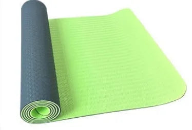 6mm TPE beginner yoga mat in black, rolled on wooden floor with textured non-slip surface visible