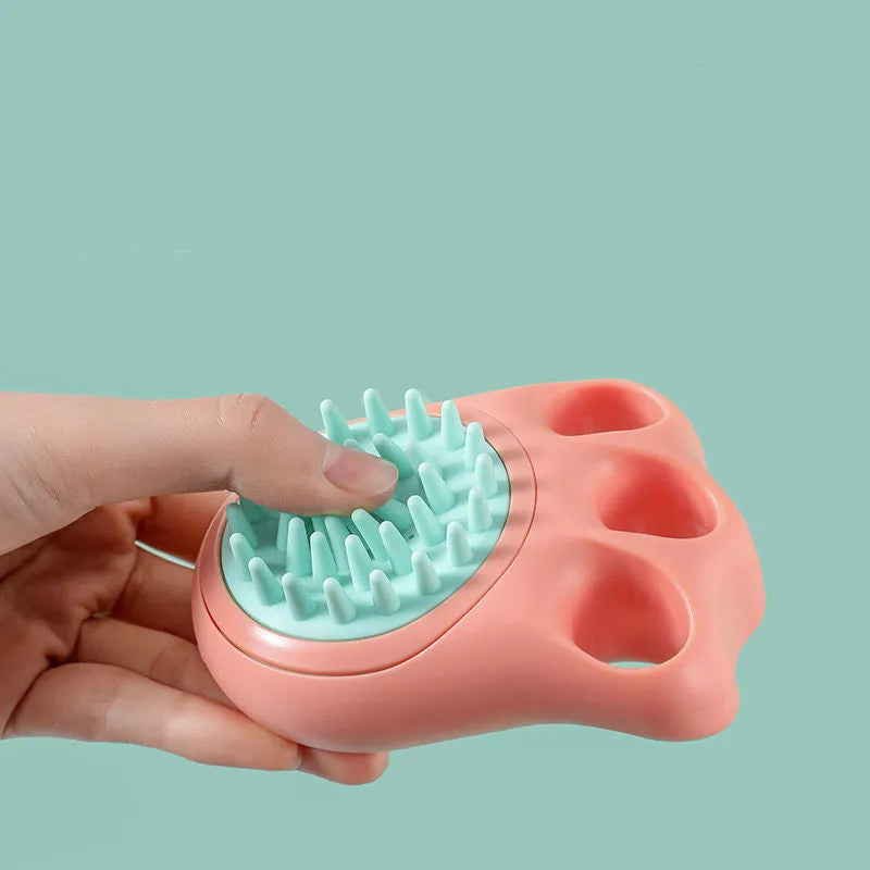 Claw-shaped silicone bath brush for dogs and cats in blue, pink, white, or yellow.