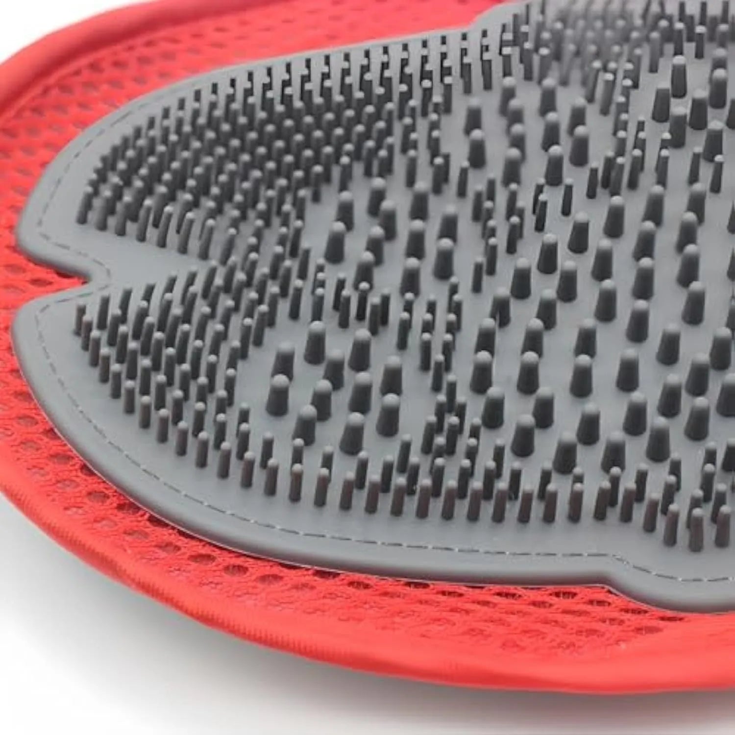 Red pet bathing glove combining a brush and grooming mitt for washing dogs or cats.