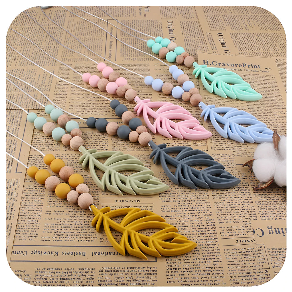 Silicone leaf teether necklace for babies over 3 months, about 35g, shown in mint green, bean green, pink, grey, turmeric, and blue