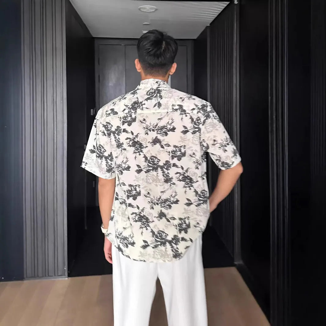Loose black and white floral print short sleeve casual shirt for women on a hanger