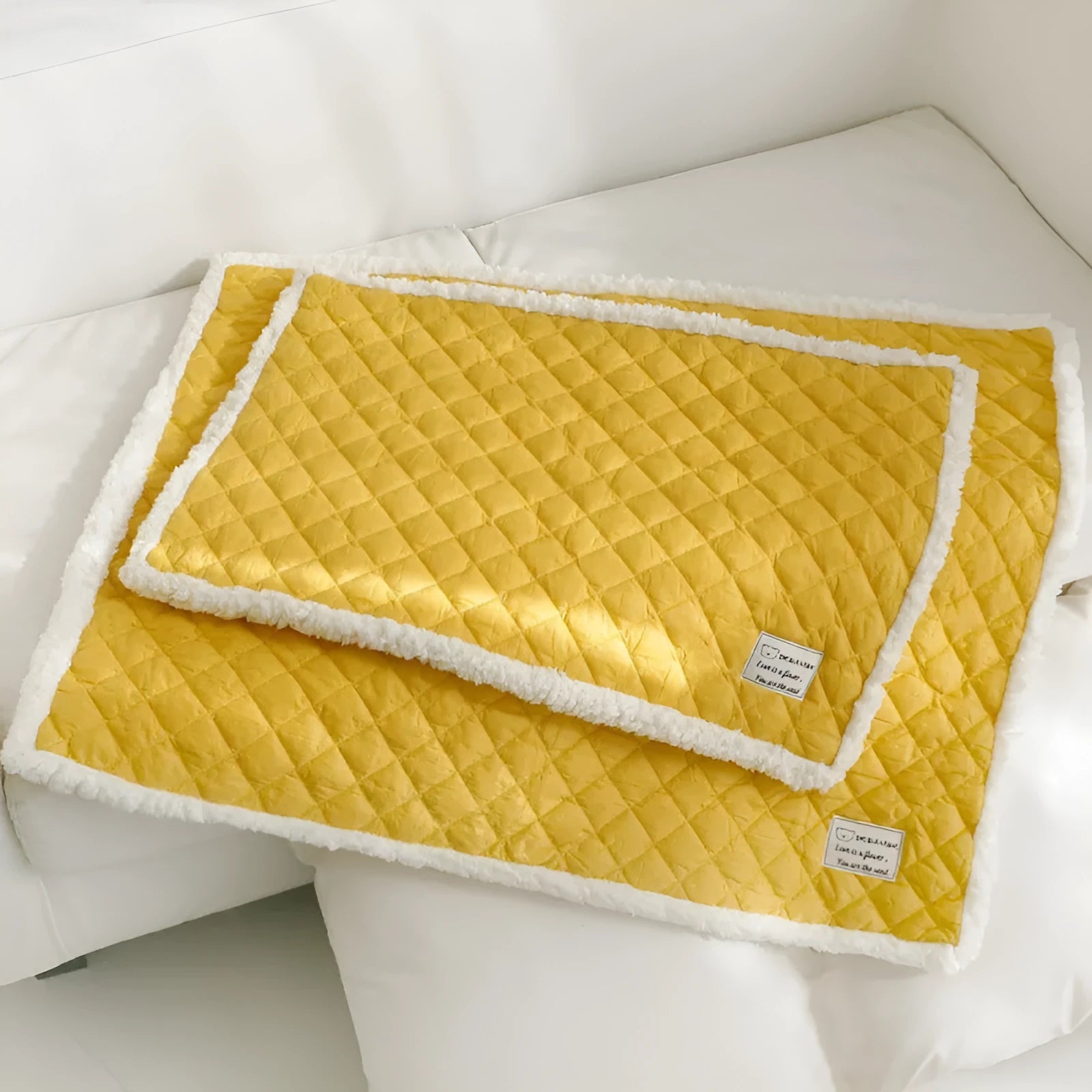 Blue quilted terry cloth pet blanket for cats showing textured surface and size scale.