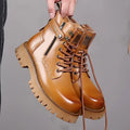 Men's light brown high-top Martin boots with a thick rubber sole and side zipper on a white background.