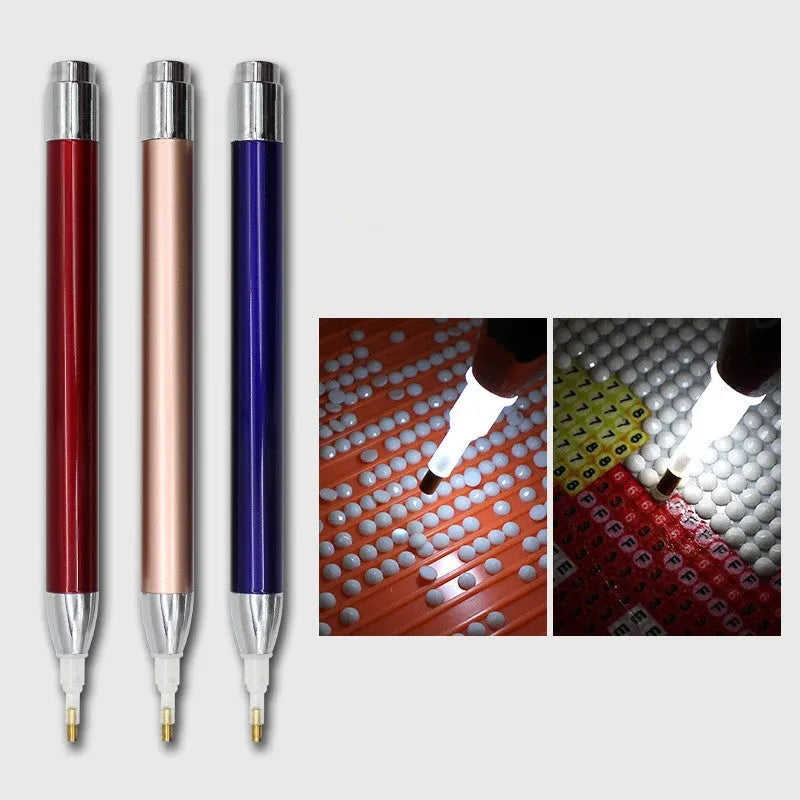 Blue luminous aluminium alloy drill pen for diamond painting and cross stitch crafts on a dark surface.