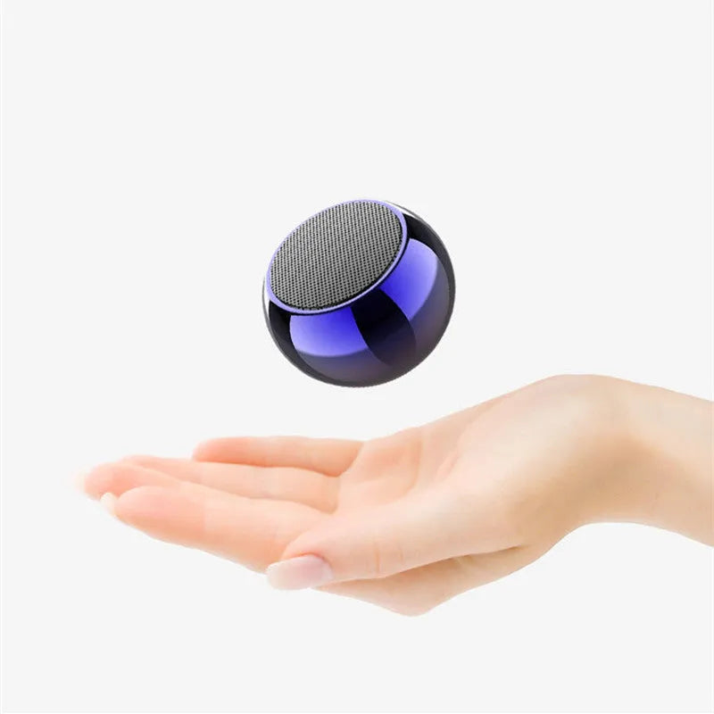 Small silver aluminium Bluetooth speaker showing USB port and compact size