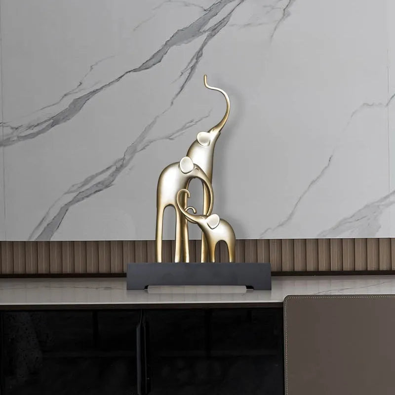Fortune Bring Elephant decorative resin statue in gold on a wooden shelf.