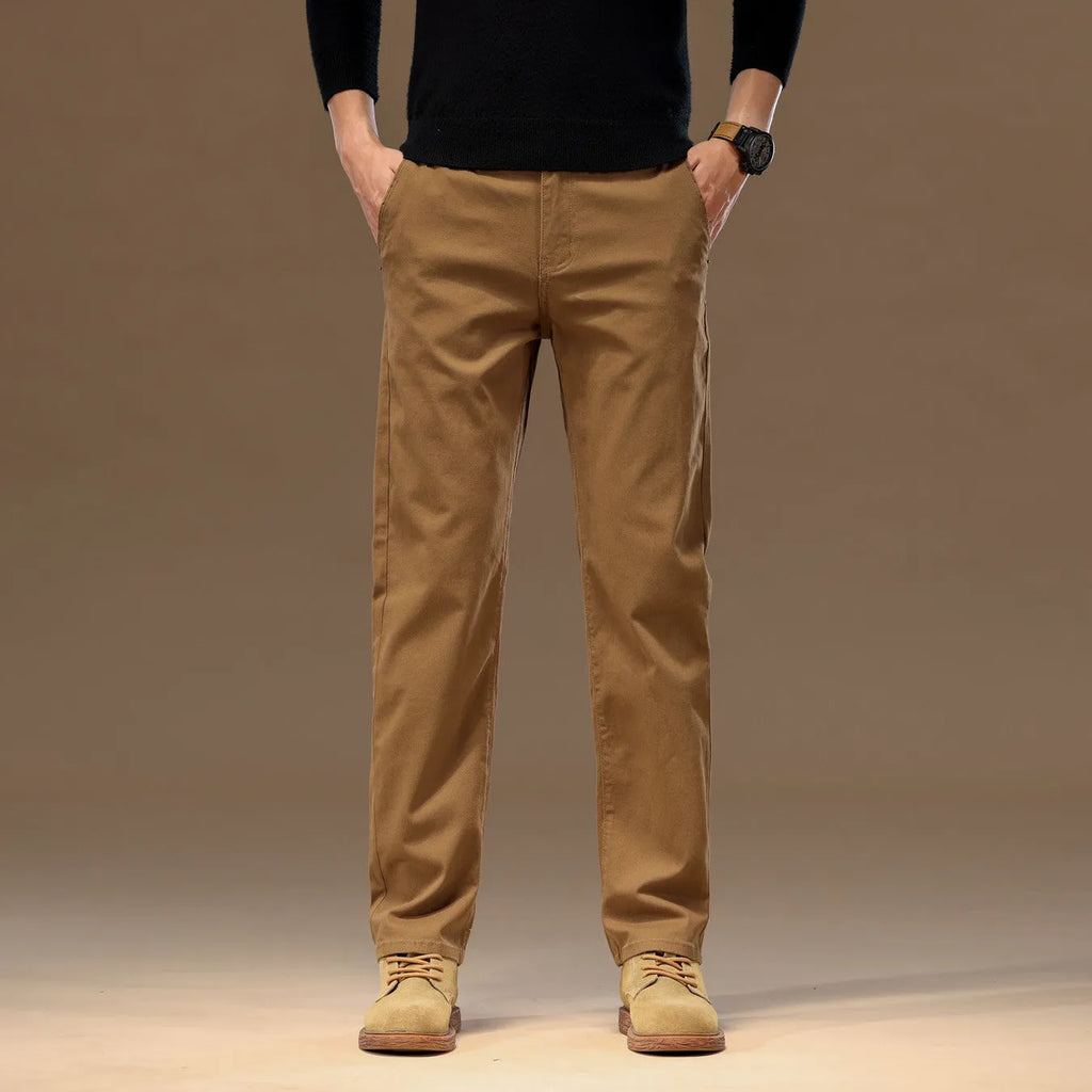 Men's cotton denim loose straight casual trousers in rust red with zip fly and elastic waist, front view