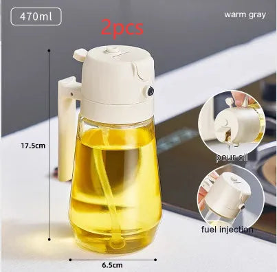 Glass olive oil sprayer bottle with ergonomic handle in beige, showing spray and pour functions.