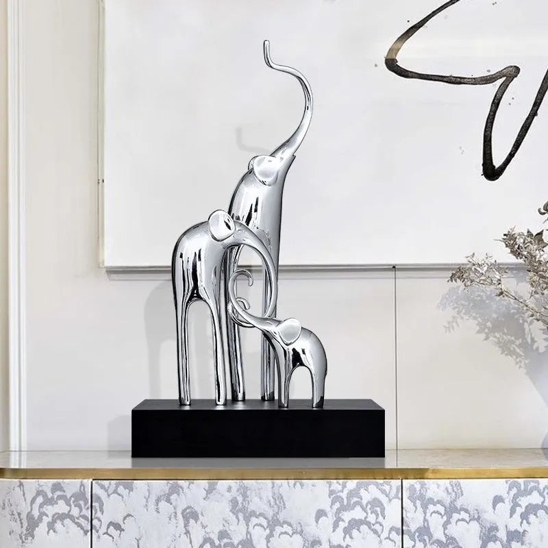 Fortune Bring Elephant decorative resin statue in gold on a wooden shelf.