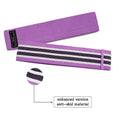 Set of three coloured fabric resistance bands and a net storage bag laid flat