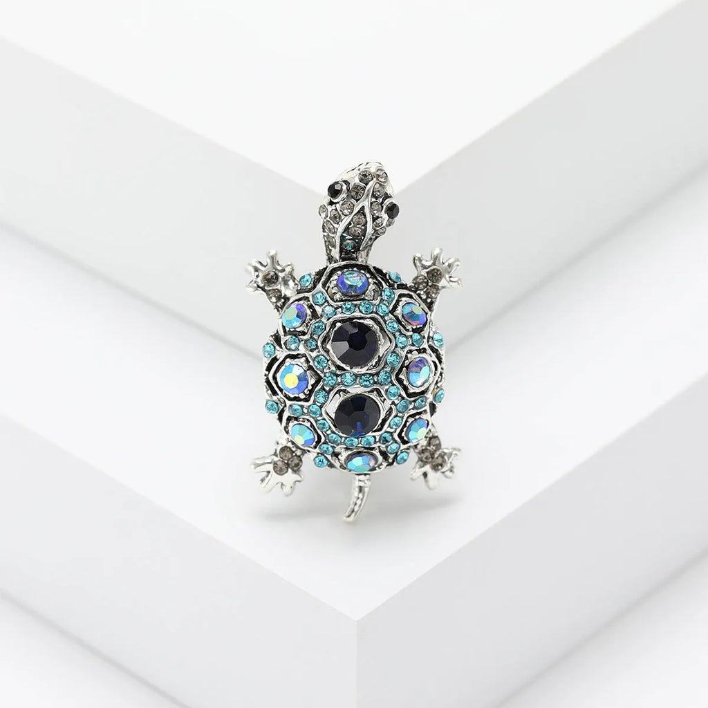 Retro-style alloy turtle brooch with rhinestone decoration, shown in blue colour.