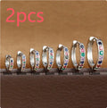 Set of three pairs of perforated circle stud earrings in gold, rose gold, and silver colours on a plain background.