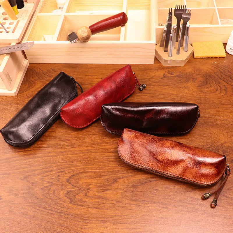 Leather glasses buggy bag in first layer cowhide with belt clip, shown in black, burgundy, brown or light brown.