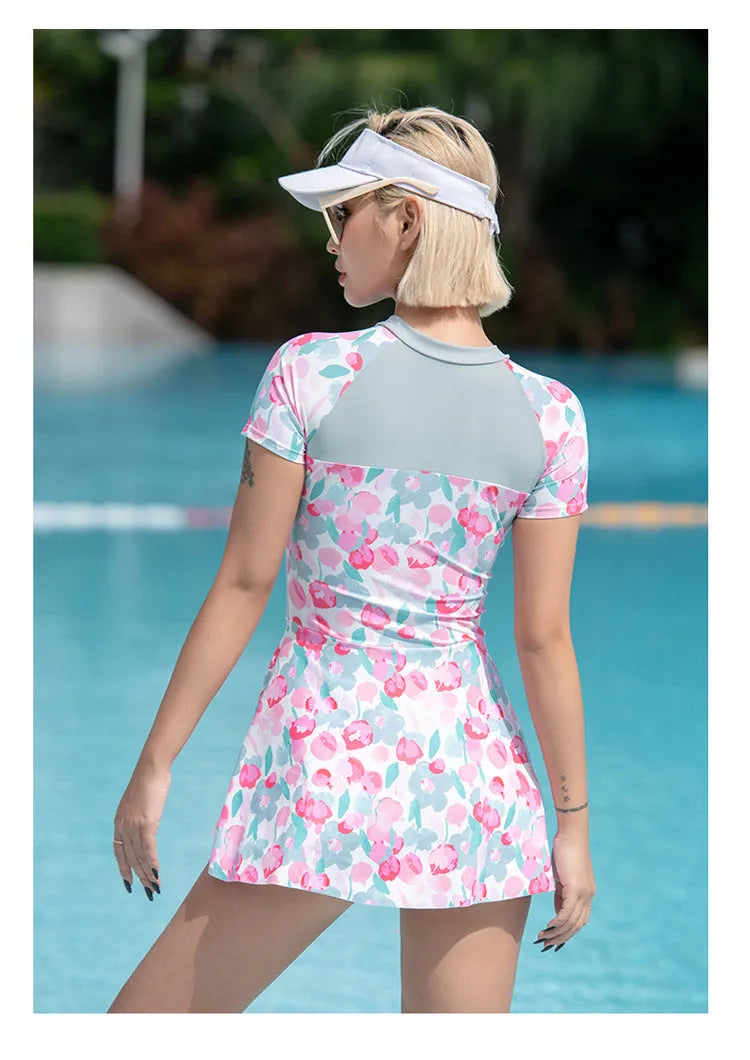 Plus size women's one-piece swimsuit with a printed colour pattern, shown on a mannequin.