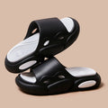 Two-colour EVA slippers showing black and white design with thick sole and leather lining