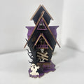 DIY wooden glowing haunted house Halloween table decoration and candlestick holder.