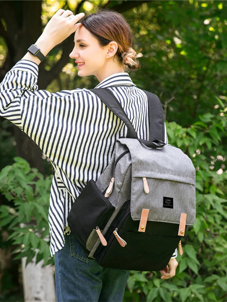 LAND Mommy large grey Oxford cloth diaper backpack with changing mat, shown on a table