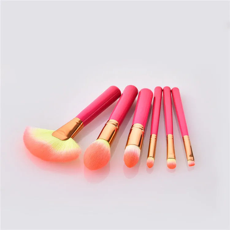 Pink wooden handle synthetic bristle makeup brush set in a compact case