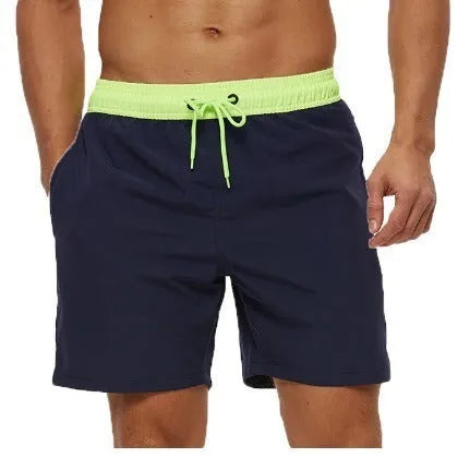 Men's blue stitching waist training shorts with zipper pockets and a drawstring, laid flat.