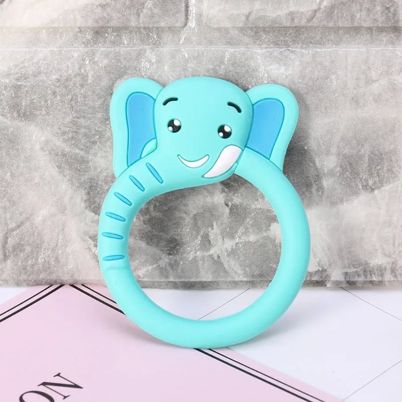 Three silicone baby molar teethers in brown, blue, and yellow on a light background