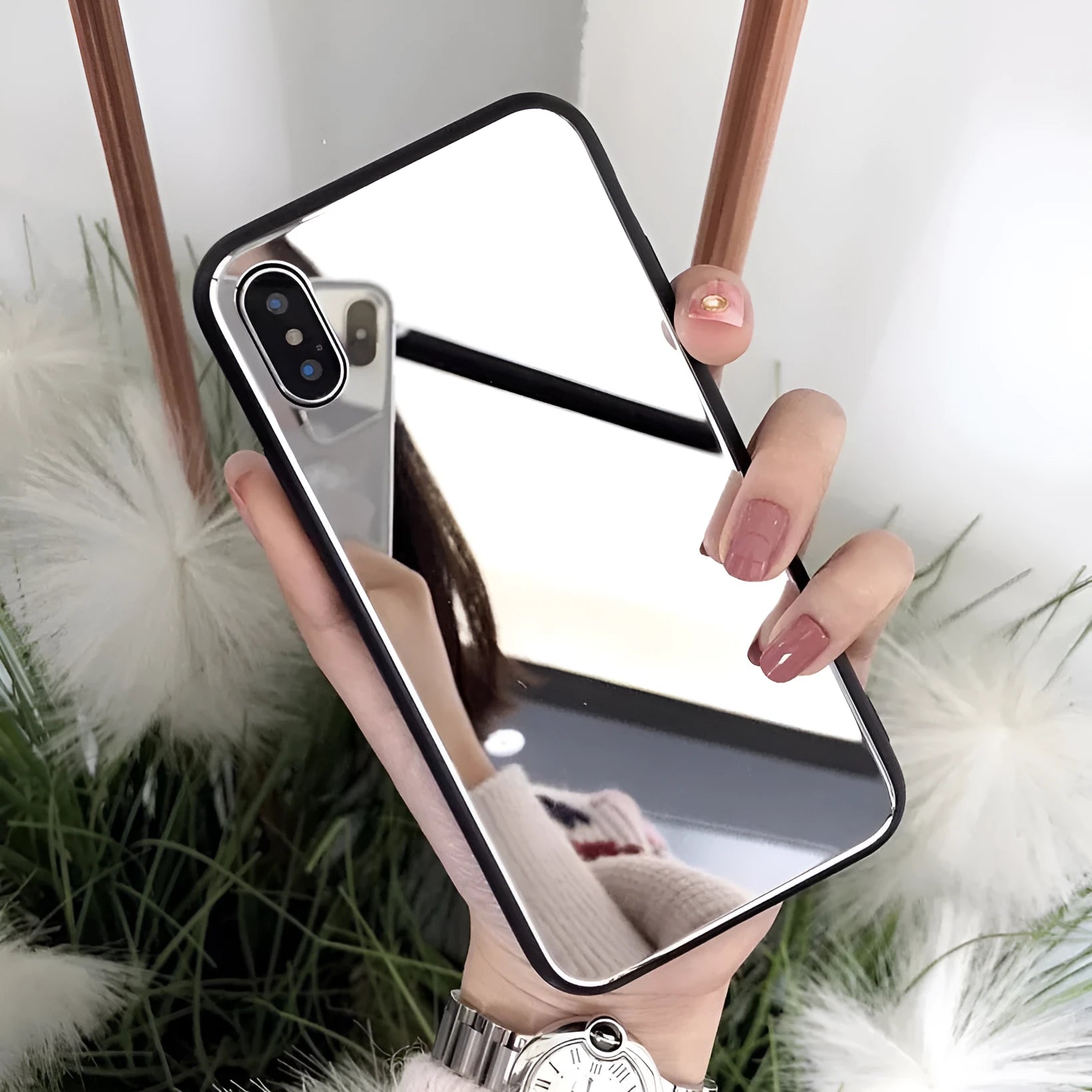Black phone case for iPhone with a reflective mirror surface on the back.
