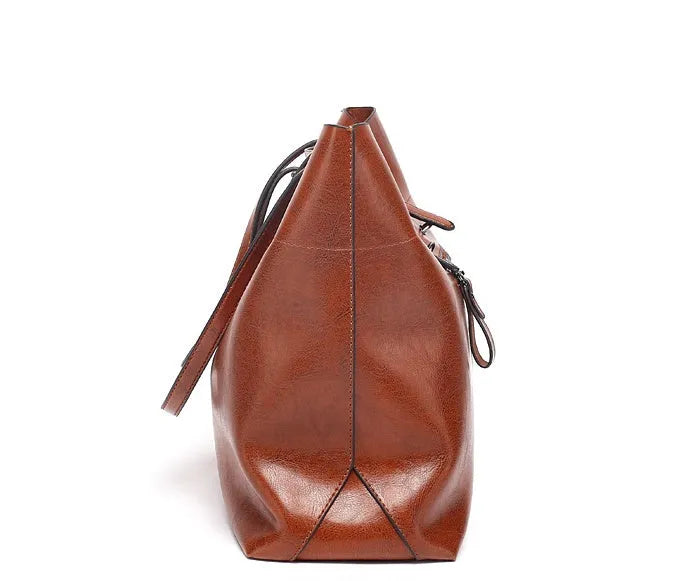 Horizontal waxed cowhide leather women's crossbody handbag showing internal phone pocket and two compartments.