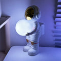 Spaceman starry sky projection lamp with astronaut holding moon design in fantasy painted finish