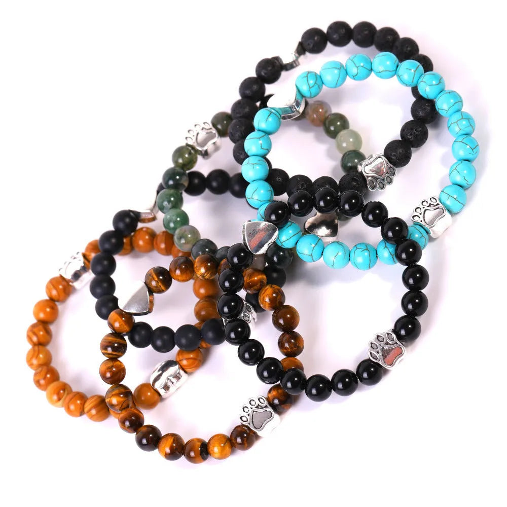 Tigereye and Indian agate stone beaded bracelet with a silver dog's paw charm and a geometric peach heart charm on a white background.