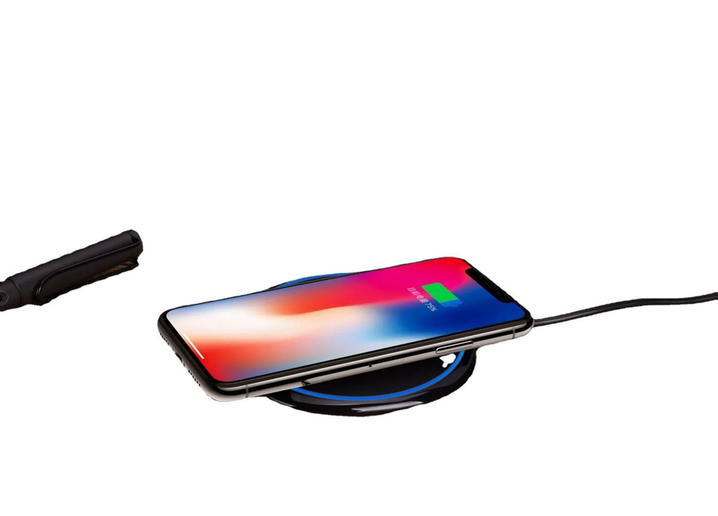 Black 15W fast wireless charger on a desk, glossy surface with indicator light