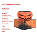 Plastic Halloween pumpkin candy bowl with motion activated skeleton hand, glowing red eyes, in Khaki colour, on a table with candy.