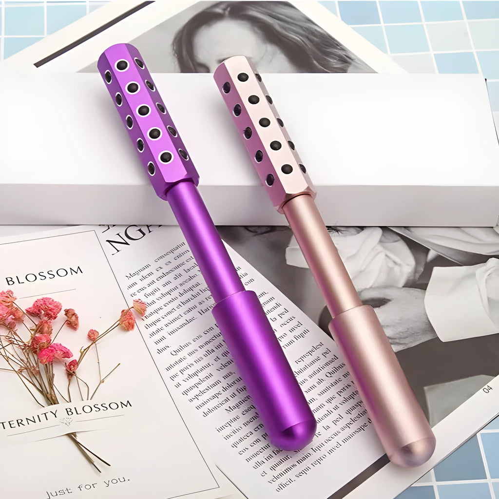 Purple handheld facial massage roller with germanium particles on a white background.