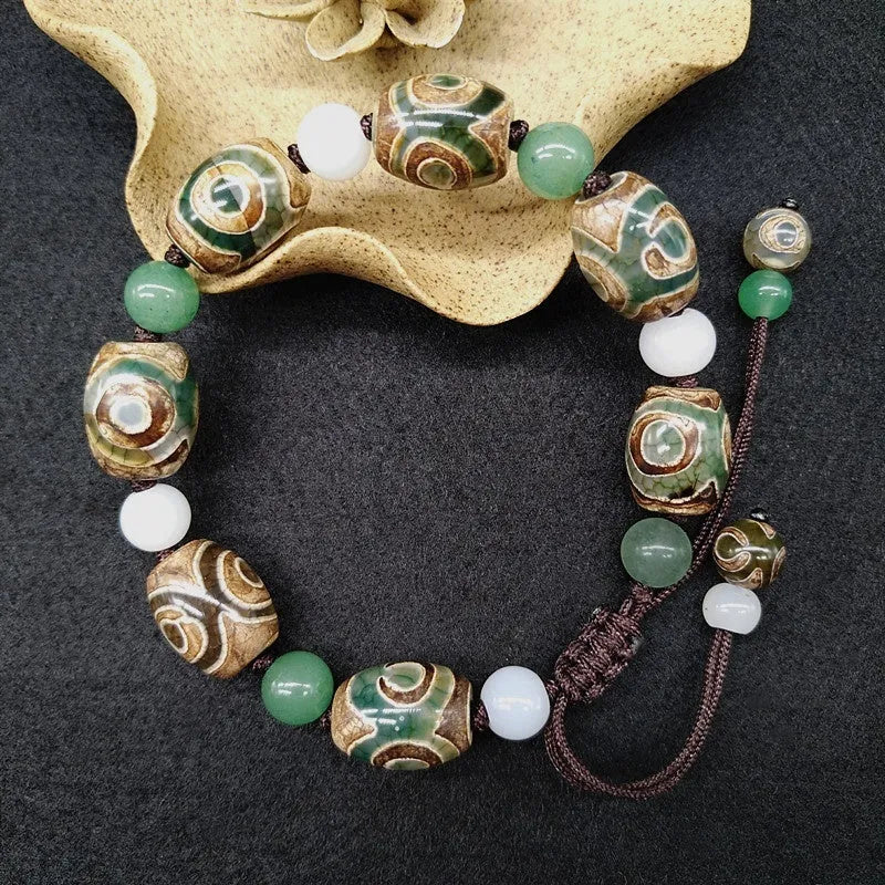 Green agate Tibetan bracelet with three-eye geometric bead pattern and adjustable cord closure