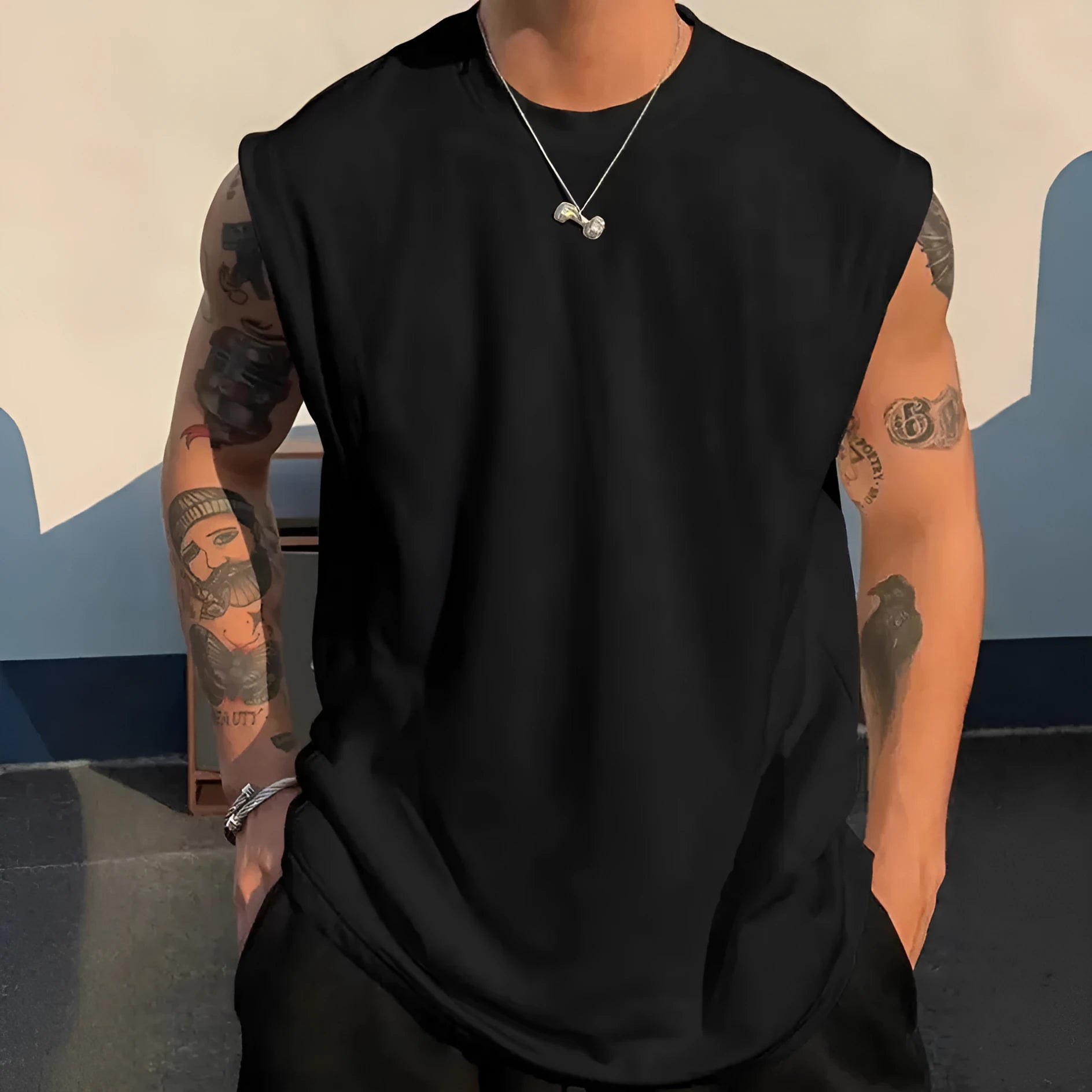 Men's loose cotton tank top in solid colours showing straight hem design and sleeveless cut