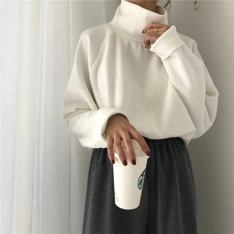 Women's loose-fitting long-sleeve top with a half-high collar in a solid colour.