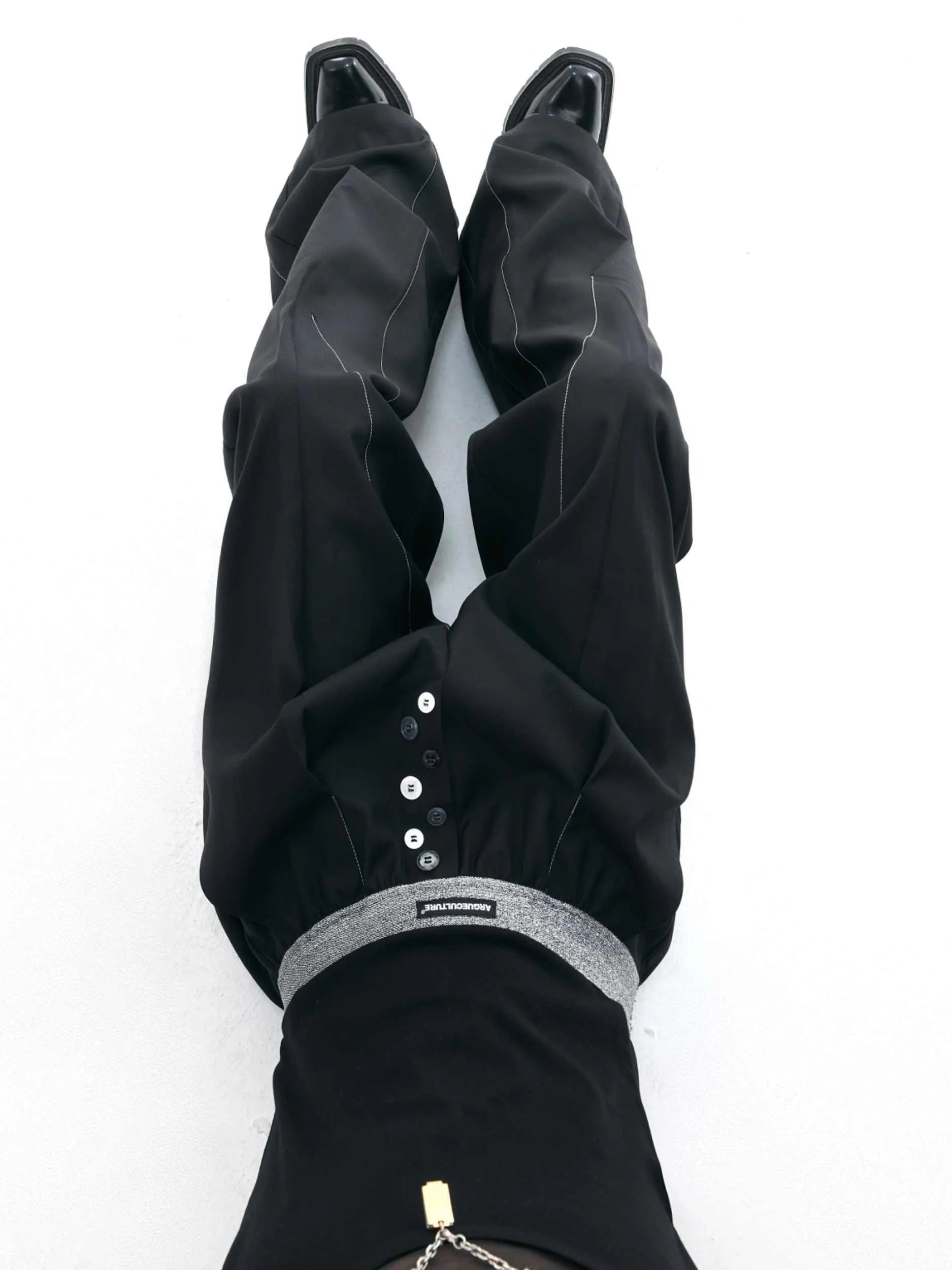 A pair of high-waisted straight-leg casual trousers in a black polyester-cotton blend with a button fly and open hem.