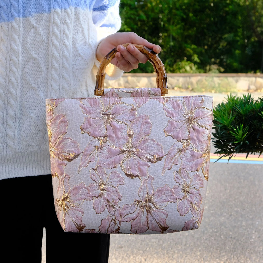 Light blue canvas shoulder bag with gold floral decoration and double shoulder straps