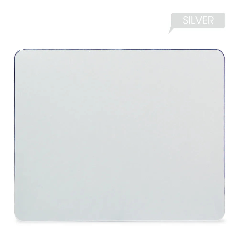 Black aluminium alloy double-sided mouse pad on a desk with a computer mouse on top