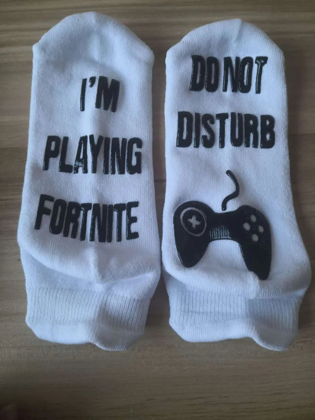 Cotton dispensing socks with 3D letter print, shown in black, blue, and white, with short, medium, and long tube lengths