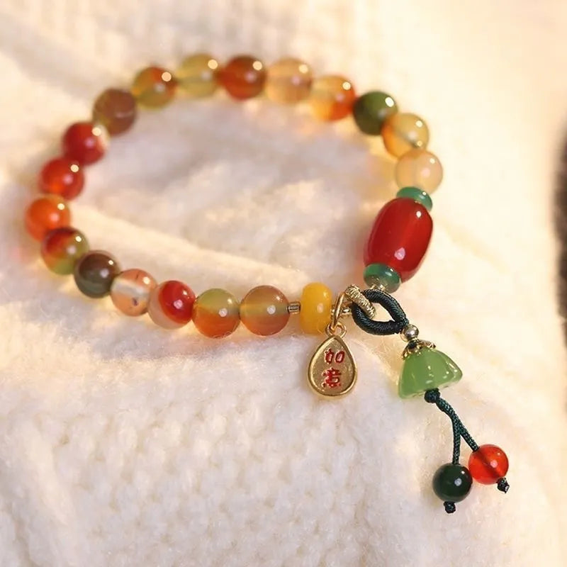 Close-up of a manually crafted lotus motif bracelet made from mixed materials in a national style.